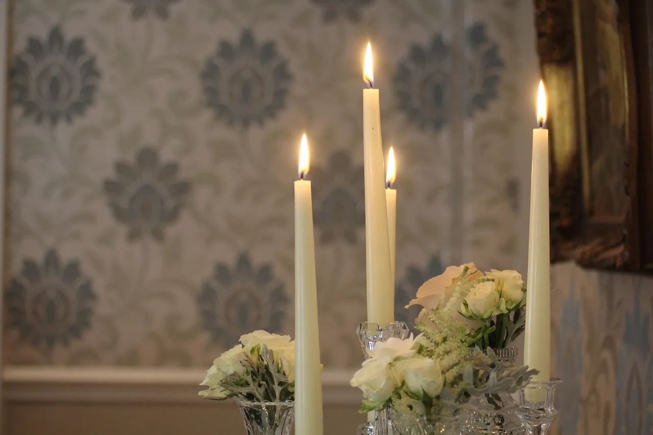 Cluster of candles glowing on a reception table