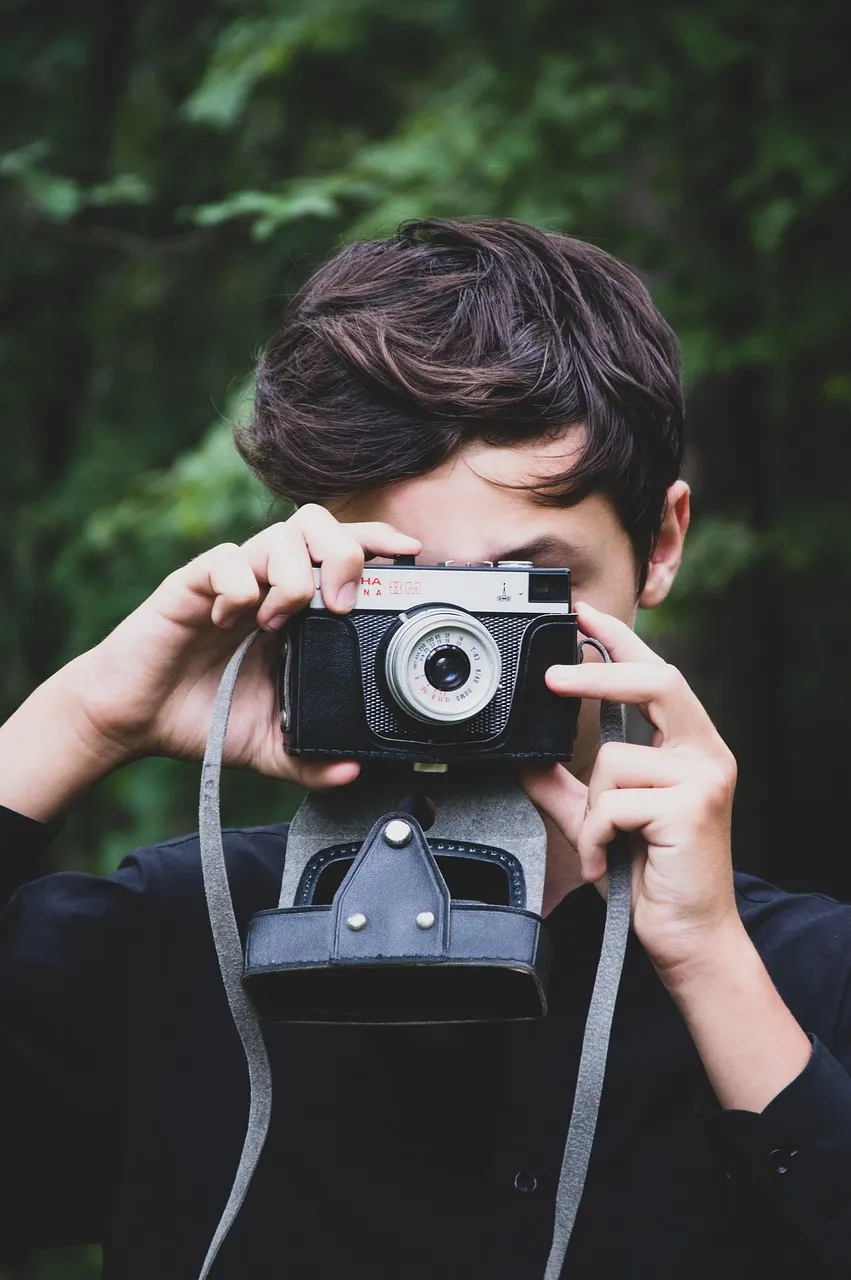 Elowen Hart holding her camera while photographing a wedding